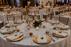 the tables are set with white linens and gold chargers