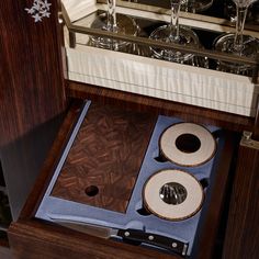 two wine glasses are sitting in a wooden box