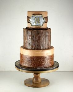 a three tiered cake with wood and metal decorations on it's top stand