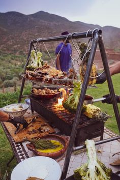 an outdoor bbq grill with food on it