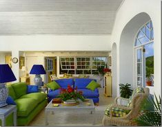 a living room filled with furniture and lots of windows