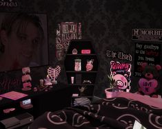 a bedroom with pink and black decor on the walls