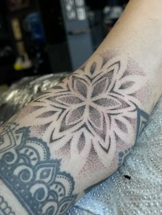 a person's arm with a tattoo on it and a flower in the middle