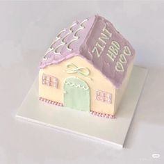 a cake shaped like a small house with the words happy new year written on it