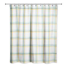 a white shower curtain with yellow and blue plaid