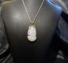 Beautiful translucent Hetian mutton fat jade pendant necklace dating from the Qing Dynasty. The ornate mounting is 14K yellow gold, hallmarked 585. The neck chain is an adjustable length made of 18K yellow gold over sterling silver. Very fine carving. Color is white with a small russet area on the back side. Fine condition with no chips or cracks. Pendant length is approximately 2.25 inches; width s 1.25 inches at the widest point. Weighs 24.1 grams. A very fine piece of handmade jewelry with hi Elegant Engraved Jade Necklace, Hallmarked Oval Jade Necklaces, Oval Jade Necklaces With Hallmark, Antique Jade Pendant Necklace, Collectible Jade Pendant Necklaces, Exquisite Carved Gold Jewelry, Collectible Jade Pendant Jewelry, Elegant Jade Jewelry For Collectors, Elegant Collectible Jade Jewelry