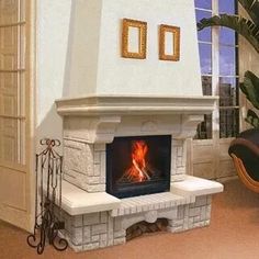 a living room with a fire place in the center and two pictures on the wall