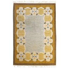 an old rug with yellow and blue accents