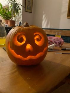 a carved pumpkin sitting on top of a wooden table