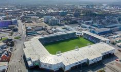 an aerial view of a soccer field in the middle of a city with lots of buildings