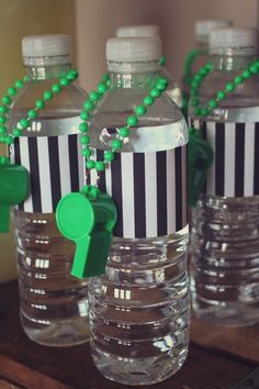 some water bottles with green and black decorations on them