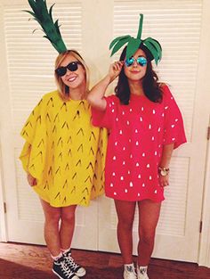 two girls wearing pineapple costumes standing next to each other in front of a door