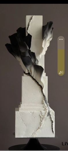 a white and black sculpture sitting on top of a table