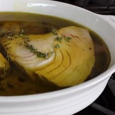 a white bowl filled with food on top of a stove