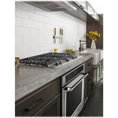 a stove top oven sitting inside of a kitchen next to a sink and countertop