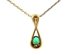 Necklace Specifications:Metal: 18K Yellow GoldGram Weight: 3.5 gramsPendant Diameter: 0.25" x 0.75"Chain Length: 16"Gemstone Specifications:Gemstone: EmeraldGemstone Color: GreenGemstone Shape: ovalEmerald Measurements: 5 x 3.8 x 2.25 mm Emerald Carat weight: ~0.22 CaratsDiamond Count: 1 brilliant cutDiamond Color: GDiamond Clarity: VSDiamond Carat Weight: 0.07 caratsStamped: "18k"Condition: Vintage, Excellent Formal Birthstone Pendant Necklace, Oval Yellow Gold Diamond Necklace With Gemstone, Formal Yellow Gold Gemstone Pendant, Hallmarked Pear-shaped Yellow Gold Necklace, Yellow Gold Pear-shaped Hallmarked Necklace, Oval Emerald Gemstone Necklace In Yellow Gold, Oval Yellow Gold Birthstone Necklace With Gemstone, Yellow Gold Pear-shaped Diamond Necklace With Gemstone, Diamond Necklaces Hallmarked For May Birthstone