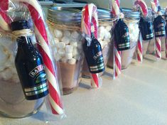 several jars filled with hot chocolate and marshmallows on a kitchen counter top