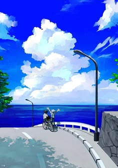 a person riding a bike down a street next to the ocean with trees on both sides