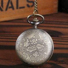 This Vintage Bronze Pocket Watch is a vintage design for anyone to appreciate. The cover is intricately crafted with a complete bronze caging, giving it added character and a retro vibe. A truly unique gift for any occasion. The bronze back cover brilliantly showcases the vintage aspects of the watch, giving it an antique feel that any pocket watch lover would enjoy. Features: Movement: Quartz Dial Material Type: Alloy Dial Diameter: 48mm Dial Window Material Type: Glass How To Use a Mechanical Vintage Skeleton Dial Pocket Watch As Gift, Vintage Bronze Pocket Watch With Antique Finish, Vintage Pocket Watch With Metal Dial Gift, Antique Gold Quartz Pocket Watch As Gift, Vintage Watches With Compass Design, Vintage Engraved Pocket Watch For Gift, Vintage Pocket Watch Gift, Vintage Brass Bronze Pocket Watch, Vintage Metal Pocket Watch As Gift