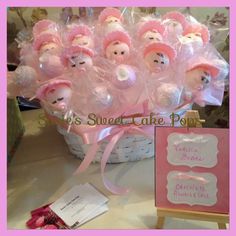 a basket filled with baby dolls next to a card