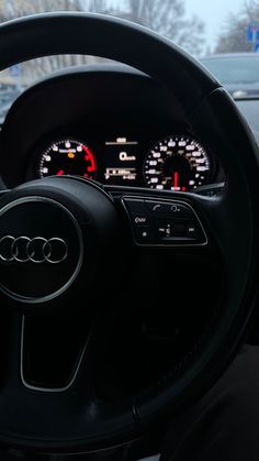 the steering wheel and dashboard of an audi car