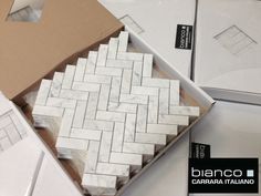 an open box with white marble tiles on it and the words bianco written in italian