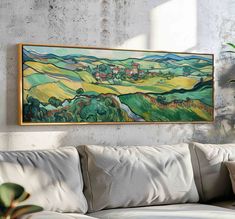 a painting hanging on the wall above a couch