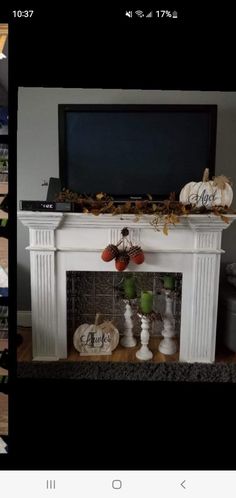 the fireplace is decorated with pumpkins and other decorations