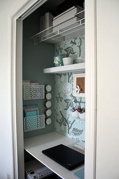 an open closet with shelves and drawers in it