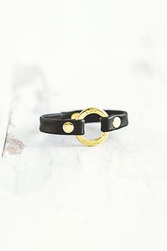 The “I Am” mantra bracelet collection was designed with the intention to empower the strength within us. Handcrafted with the softest lamb leather you’ll find the words “I AM ABUNDANT" softly etched around the gold center ring, a daily reminder to hold space with your abundance. **Contents** * Lambskin leather, zinc alloy hardware * Button clasp closure * Handmade **Care/Import** * Made in the USA **Dimensions** * Adjustable to fit wrist sizes 6.5”-8” | Giving Bracelets Gold I Am Abundant Mantra Bracelet at Free People in Black Spiritual Leather Bracelet For Everyday, Spiritual Everyday Leather Bracelet, I Am Abundant, Hold Space, Mantra Bracelet, Bracelets Gold, Bracelet Collection, Daily Reminder, Lambskin Leather