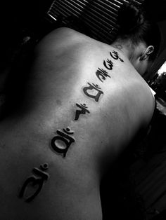 the back of a man's body with writing on it