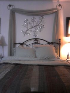 a bedroom with a bed and two lamps on either side of the headboard,