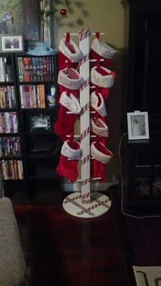 there are many pairs of red and white shoes hanging from a pole in the living room