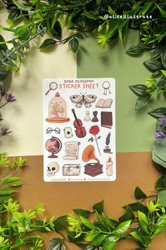 the sticker sheet is surrounded by green leaves and plants, with an assortment of items on it