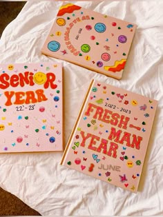 three children's books sitting on top of a white sheet covered in confetti