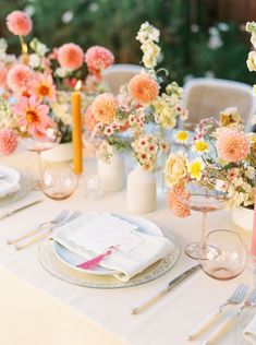 the table is set with flowers and place settings for two people to sit down at