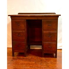 an old wooden desk with drawers on it