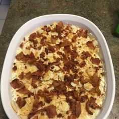 a white dish filled with food on top of a counter