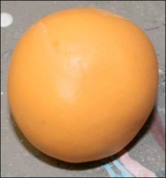 an orange ball sitting on the ground