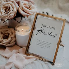 there is a candle and some flowers on the table with a sign that says the light remains