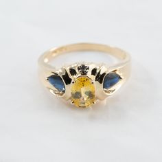 Hi. This is a very pretty blue and yellow sapphire ring with diamond accents in 14k yellow gold. It is marked 14k on the inside of the ring. The diamond accents are real. The yellow gemstone measures 5x7mm and oval in shape. The blue sapphires are pear shape. The ring finger size is 8. Sorry, we do not resize rings. The weight of the ring with the stones is 3.5 grams. This item will have insurance and signature confirmation. Thanks for looking. Yellow Oval Topaz Ring In 14k Gold, Oval Yellow Topaz Ring In 14k Gold, Oval Yellow Sapphire Ring With Center Stone, Yellow Oval Birthstone Promise Ring, Yellow Sapphire Ring With Accent Stones For Promise, Yellow Sapphire Ring With Oval Shape And Accent Stones, Oval Yellow Gold Birthstone Anniversary Ring, Oval Yellow Birthstone Anniversary Ring, Yellow Oval Birthstone Anniversary Ring