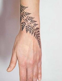 a woman's hand with a tattoo on it