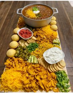 a platter filled with chips, salsa and dip