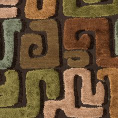 an area rug with various colors and shapes on the floor, including letters that spell out