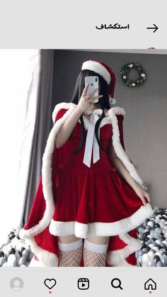 a woman dressed as santa claus taking a selfie