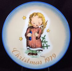 a christmas plate with an angel holding a blue bottle in it's hands and the words, christmas 1909