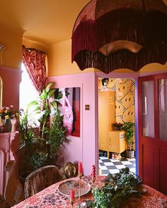 the dining room is decorated in pink and yellow