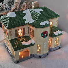 a lit up house with snow on the ground