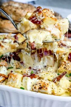 a spoon is lifting some food out of a casserole dish with meat and cheese