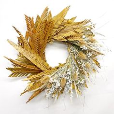 a wreath made out of dried flowers and leaves